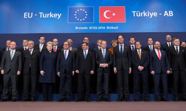 Turkish Prime Minister Ahmet Davutoglu poses with European Union leaders during a EU-Turkey summit in Brussels