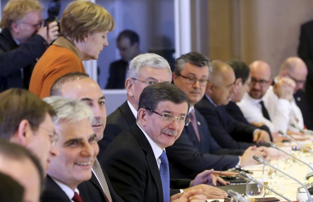 Turkish PM Davutoglu attends a lunch meeting with EU leaders including Germany's Chancellor Merkel during an EU-Turkey summit in Brussels